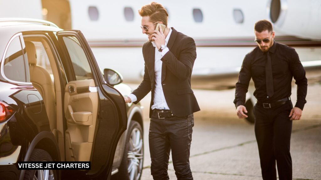 VIP passenger stepping from a private jet into a waiting black luxury vehicle, assisted by a professional chauffeur, with discreet executive security personnel positioned nearby on the tarmac.